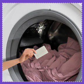 Putting eco-friendly laundry detergent sheets in the washing machine